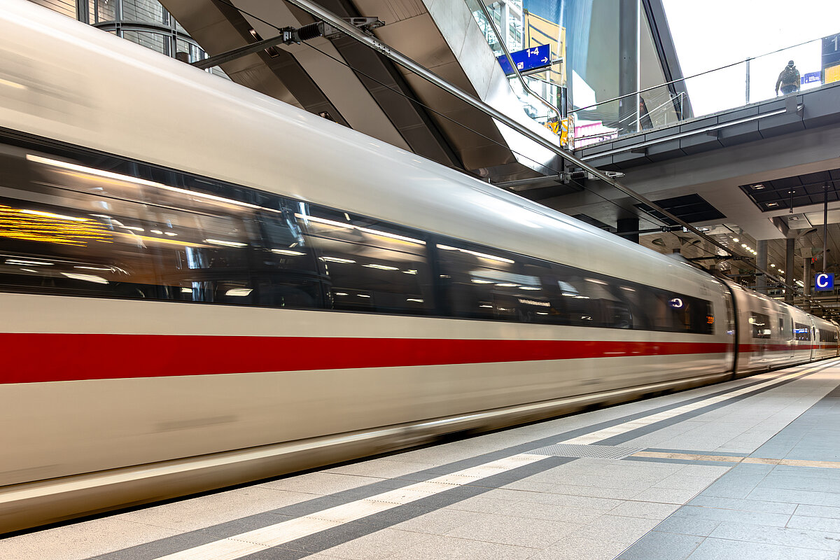 High speed train moving at station with motion blur. Modern mobility concept.